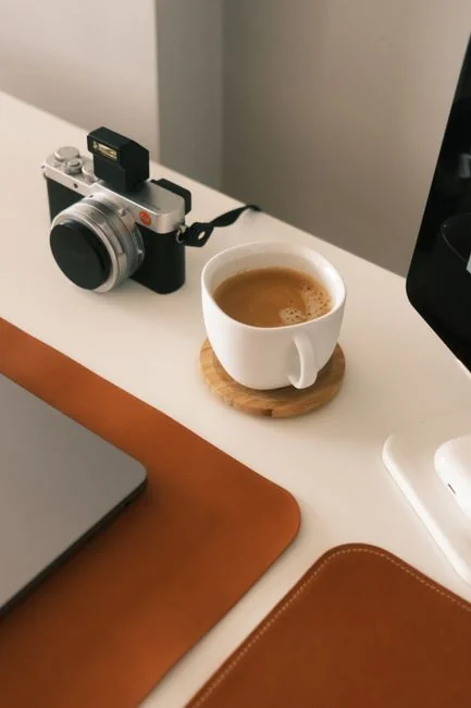 A laptop resting on a bed with web design software open, forming a comfortable workspace.