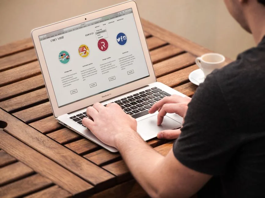 A person using a laptop to browse stock photo websites. Freelancing work in a cozy setting.